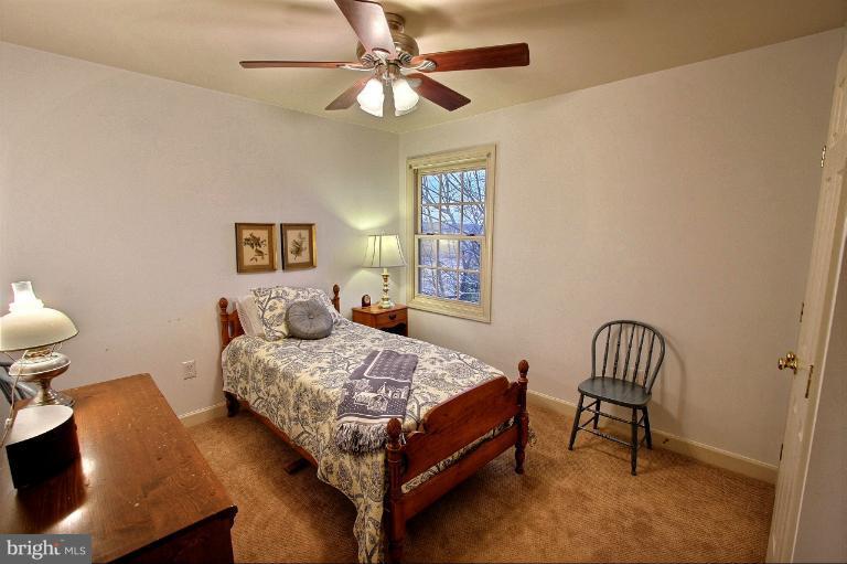 20003 Hickman Way Poolesville, MD 20837 - Photo 28 of 30 a bedroom with a bed chair and a chandelier
