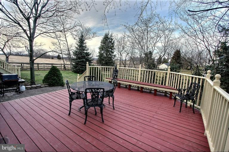 20003 Hickman Way Poolesville, MD 20837 - Photo 4 of 30 a view of a deck with table and chairs and wooden floor