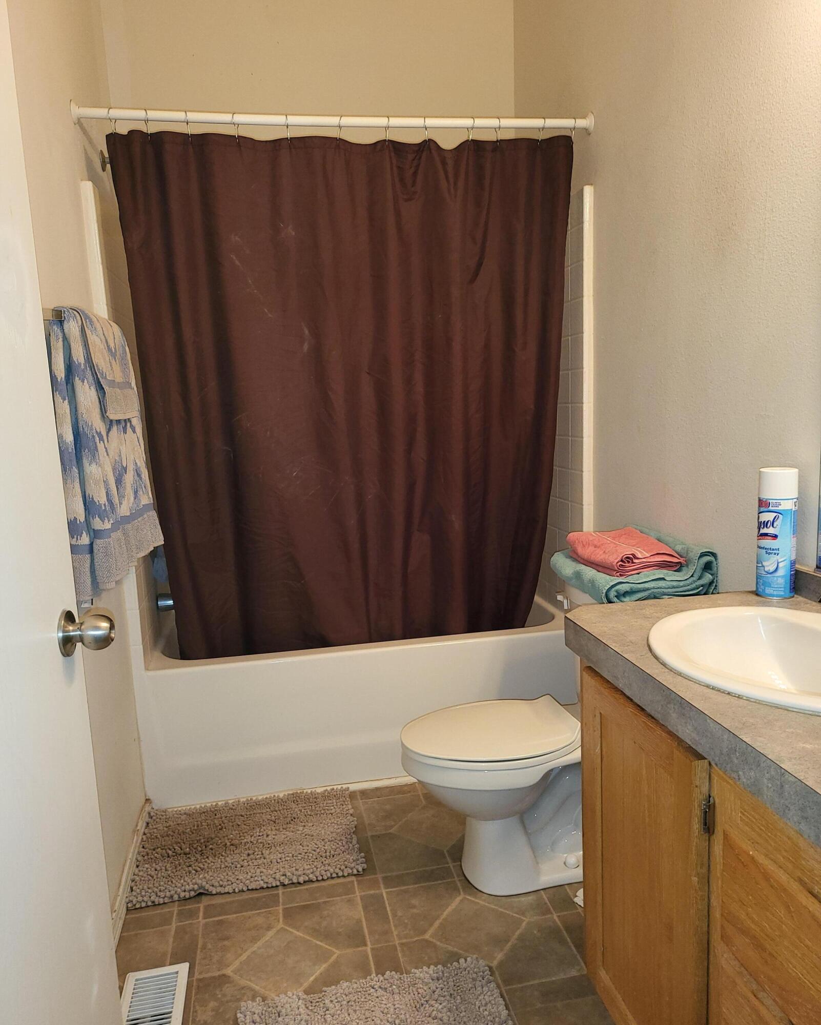 31 Juniper Way McArthur, CA 96056 - Photo 16 of 24 a bathroom with a sink a toilet a mirror and shower curtain