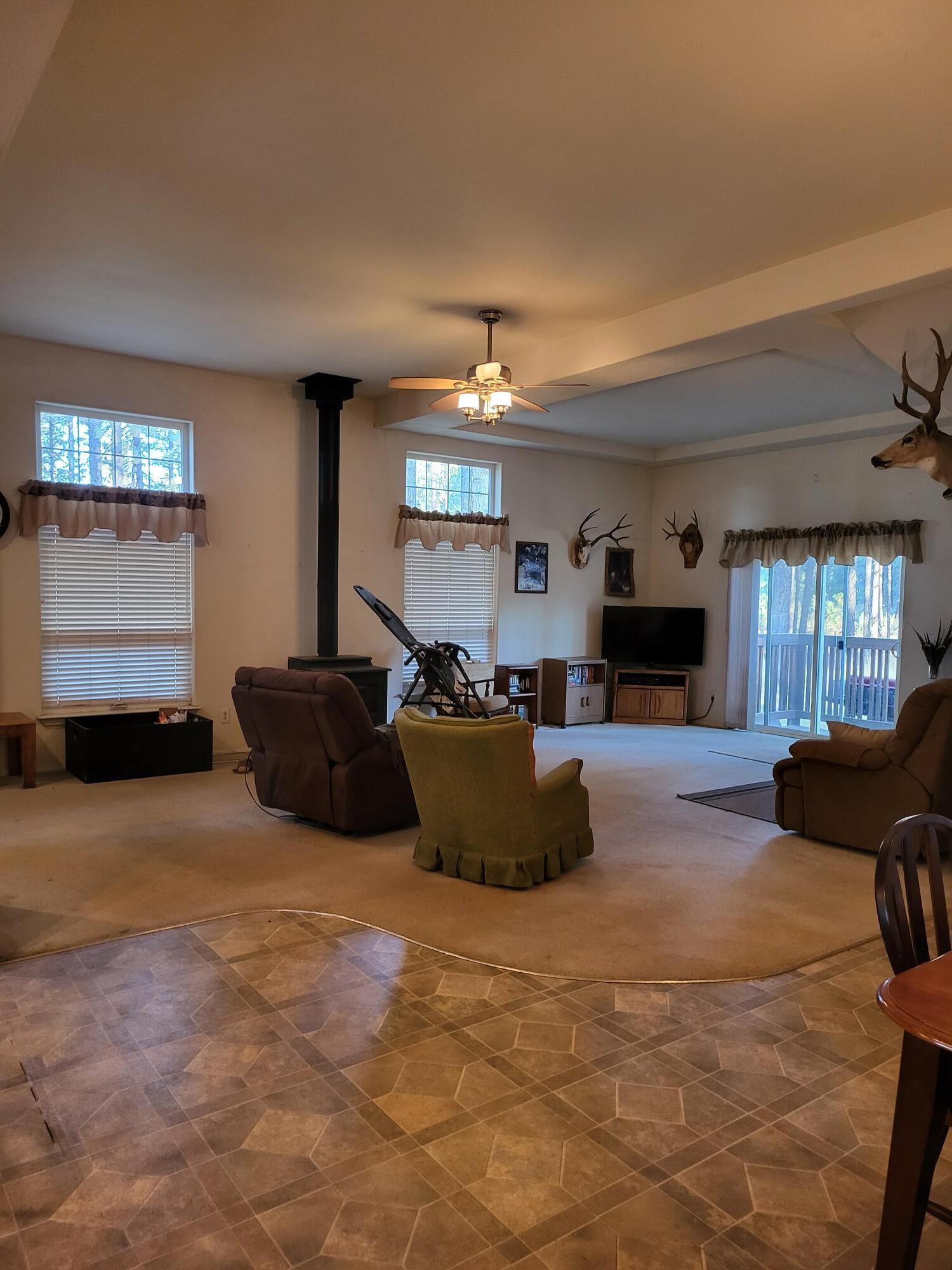 31 Juniper Way McArthur, CA 96056 - Photo 3 of 24 a living room with furniture a fireplace and a flat screen tv