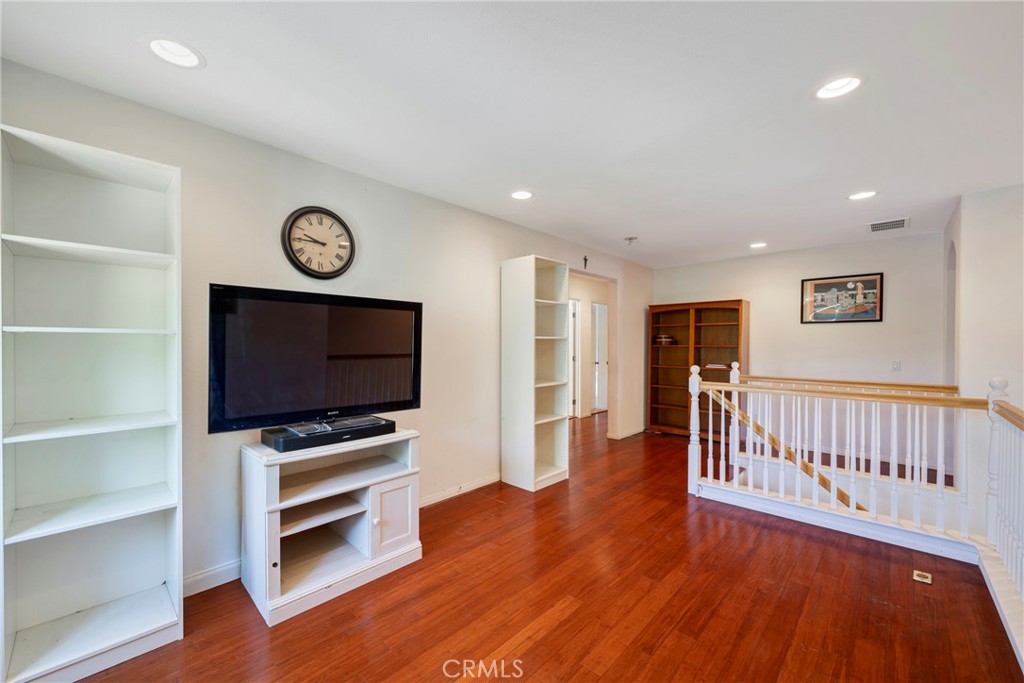 3819 St Austell Way Perris, CA 92571 - Photo 25 of 64 a view of a livingroom with wooden floor and a flat screen tv