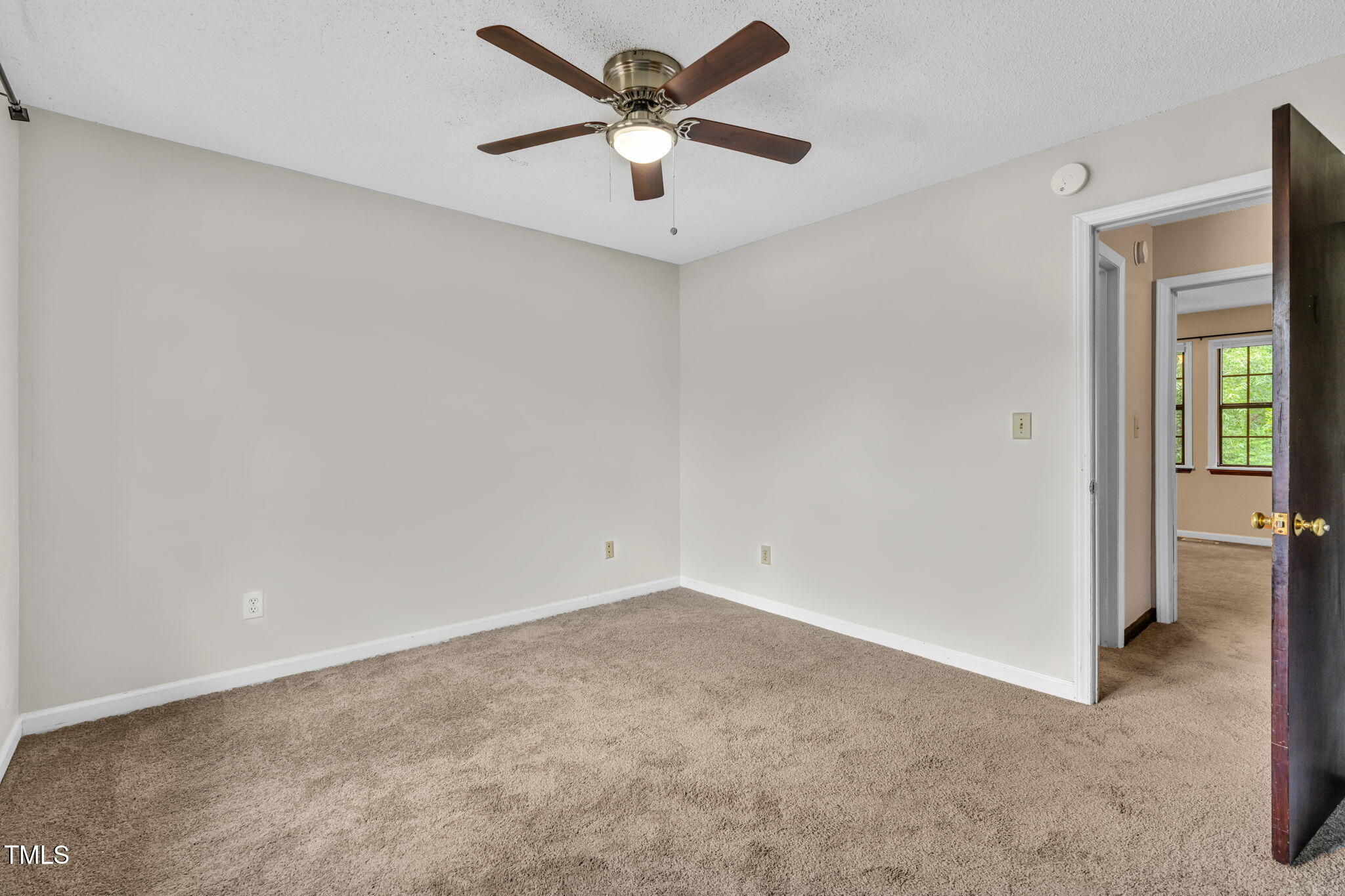 8117 Farmlea Circle Raleigh, NC 27616 - Photo 13 of 20 an empty room with a ceiling fan and a window