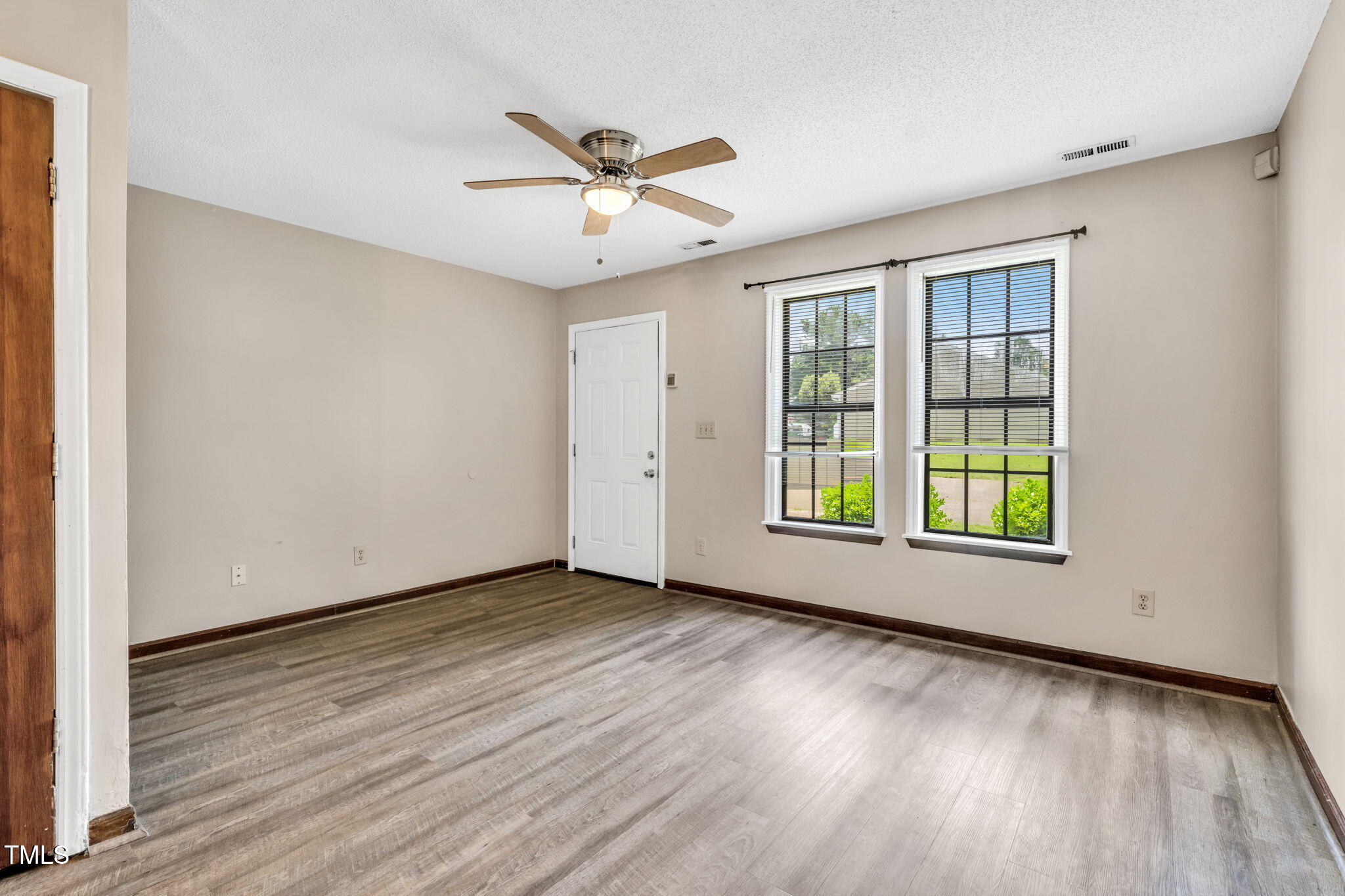 8117 Farmlea Circle Raleigh, NC 27616 - Photo 3 of 20 a view of an empty room with wooden floor and a window