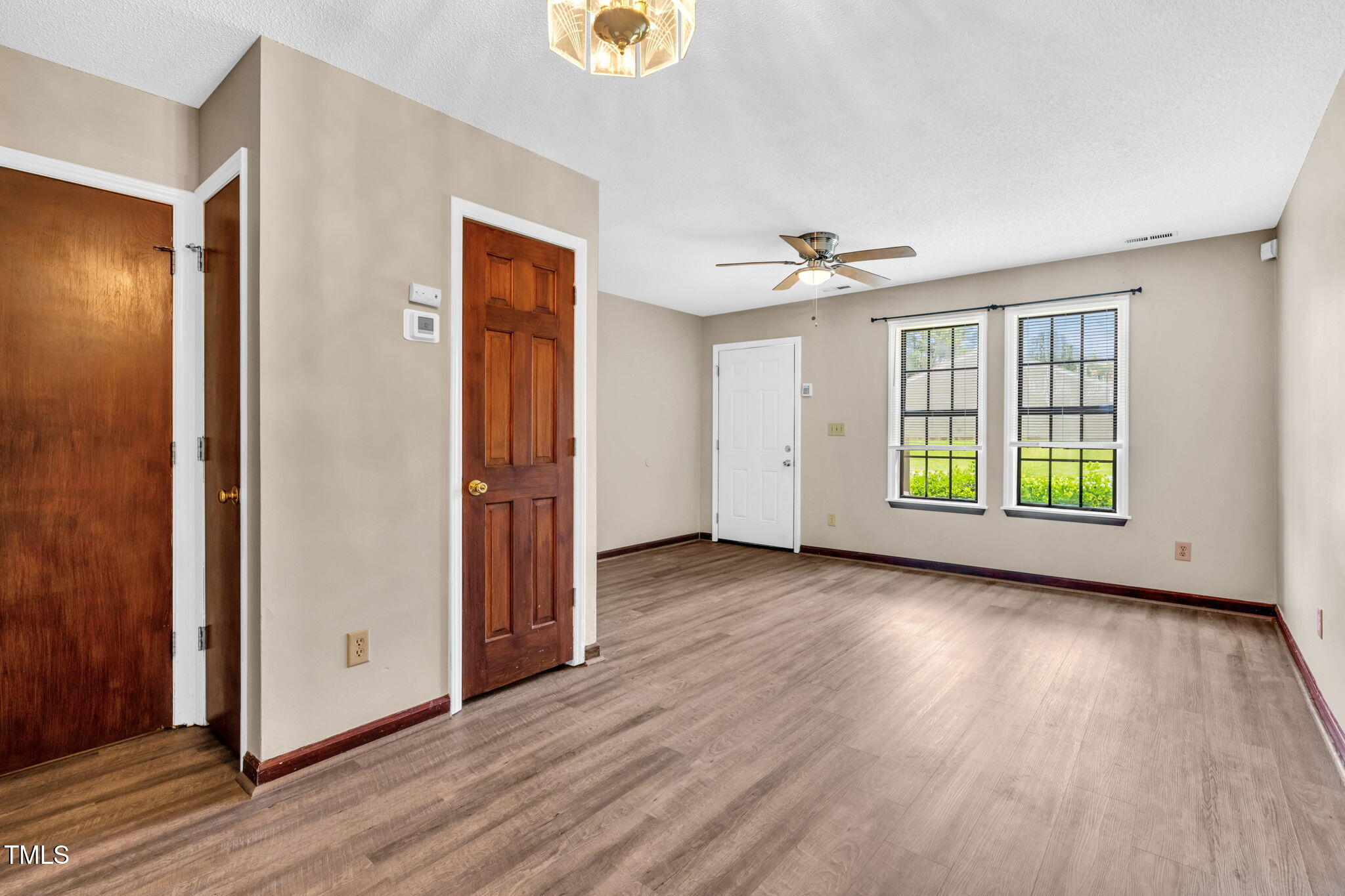 8117 Farmlea Circle Raleigh, NC 27616 - Photo 4 of 20 an empty room with wooden floor and a window
