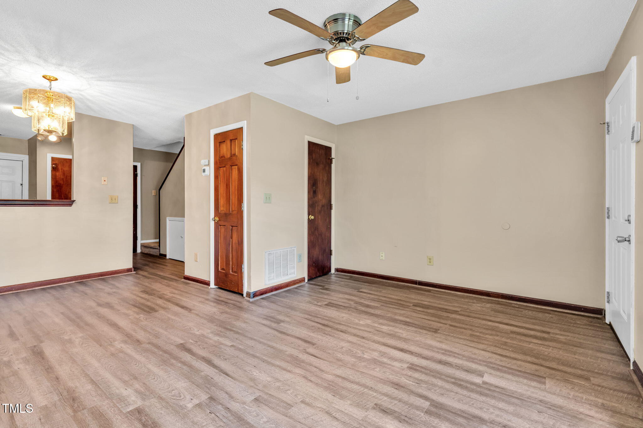 8117 Farmlea Circle Raleigh, NC 27616 - Photo 5 of 20 a view of a livingroom with wooden floor and a ceiling fan