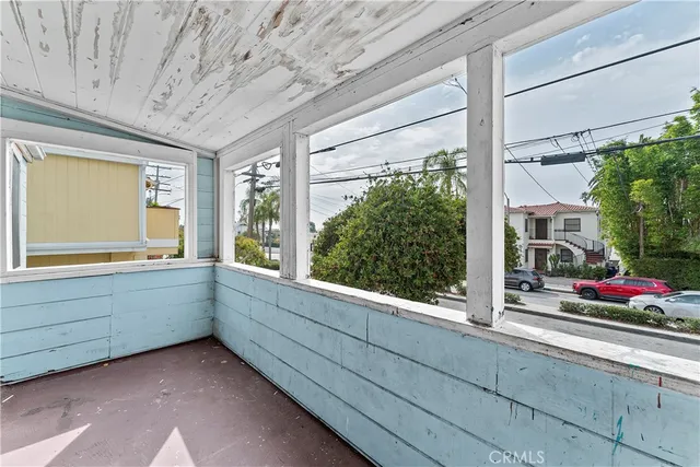 a view of house with a large window and wooden fence