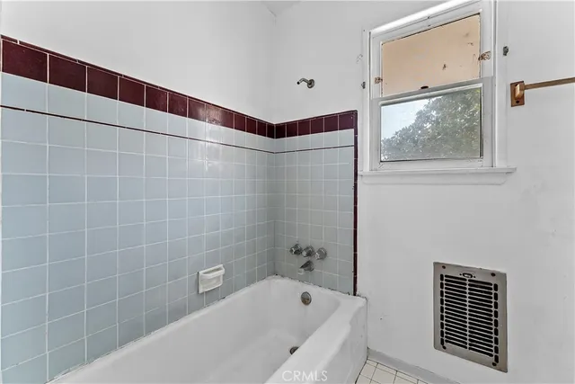 a bathroom with a bathtub and shower