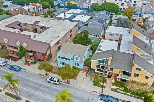 an aerial view of residential houses with outdoor space and parking