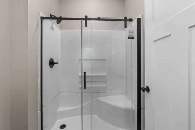 a bathroom with a shower and a bath tub
