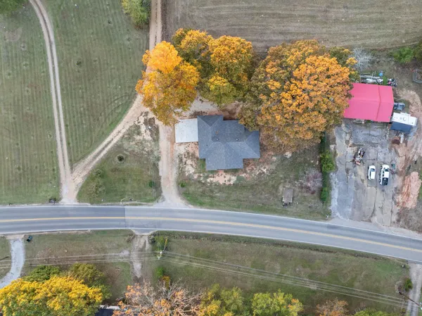 a bathroom with a granite countertop sink two mirror and shower