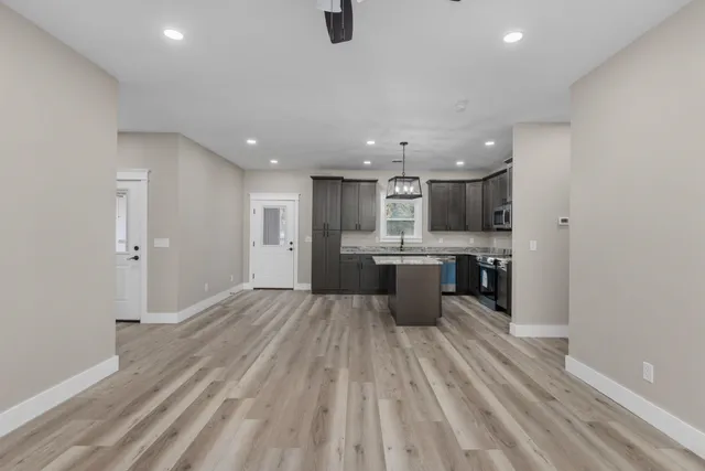 a large kitchen with a lot of counter space and stainless steel appliances