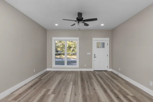 wooden floor in an empty room with a window