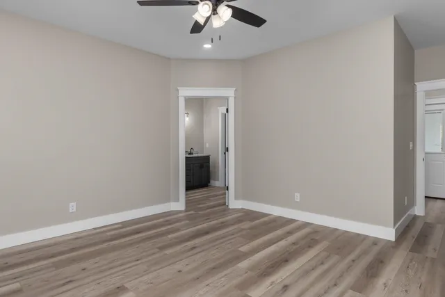 a view of an empty room with wooden floor