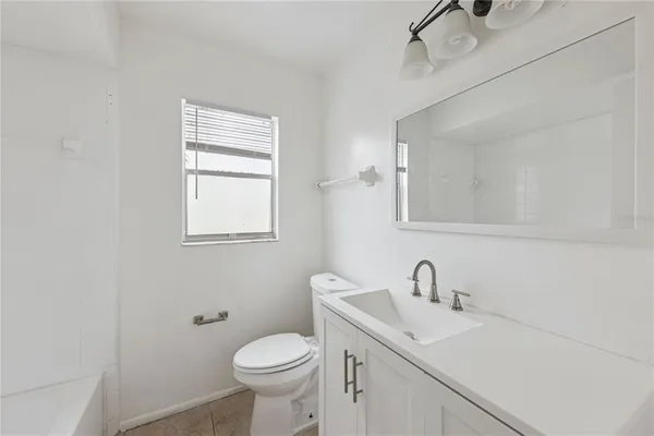 a bathroom with a sink toilet and mirror