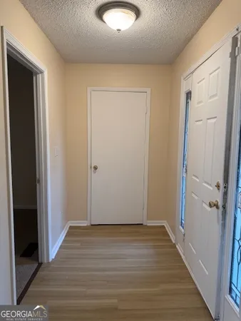an empty room with wooden floor and closet