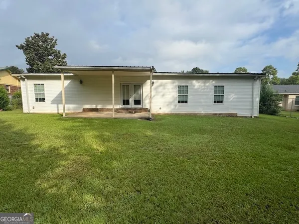 a view of a yard with a house in the background