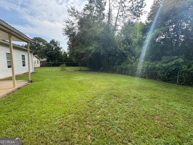 317 Emory Drive Warner Robins, GA 31093 - Photo 26 of 28 a view of a yard with a house in the background
