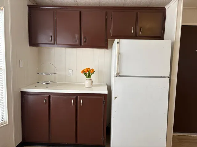 a white refrigerator freezer sitting in a kitchen