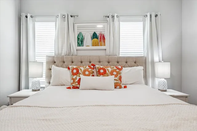 a bedroom with a bed and a painting on the wall