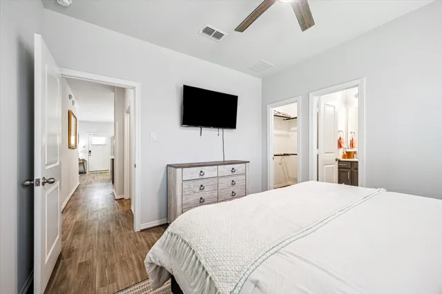 a bedroom with a bed and a flat screen tv