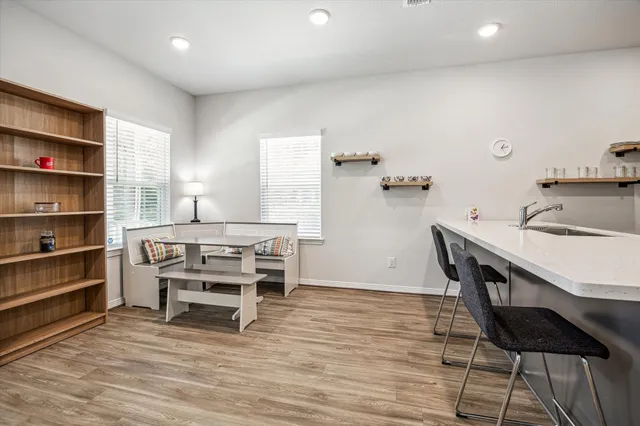 a view of a dining room with furniture and wooden floor