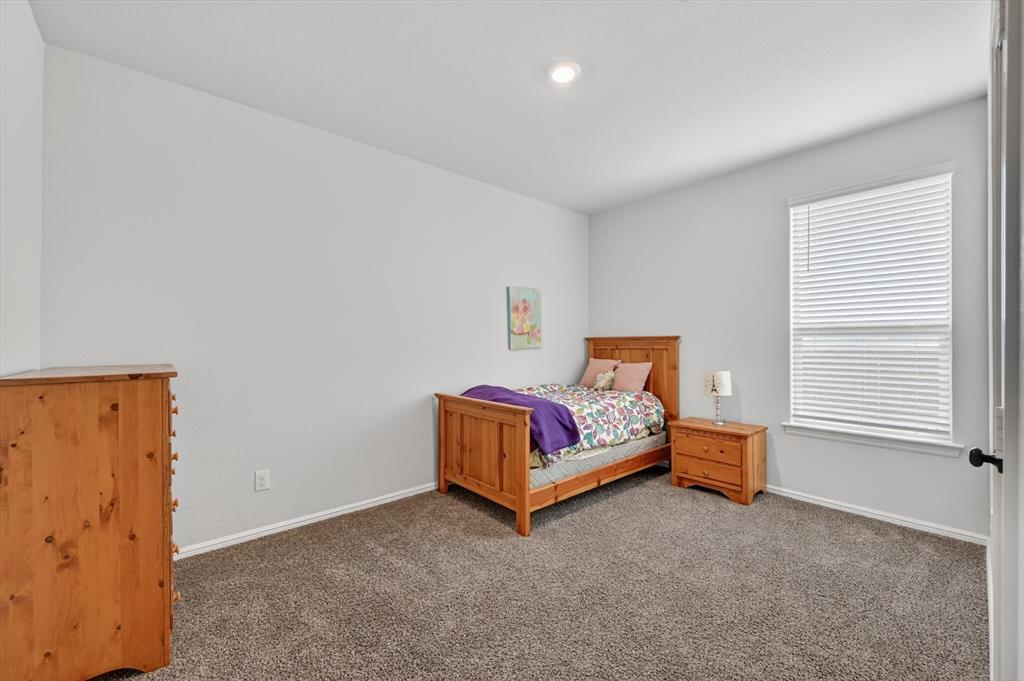 9604 Cherryville Road Fort Worth, TX 76108 - Photo 23 of 40 Carpeted room featuring a single window with blinds, white baseboards, and a recessed ceiling light