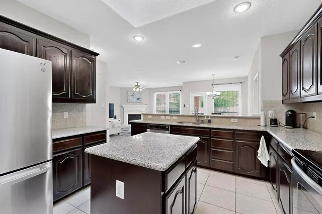 a kitchen with a stove a sink and a refrigerator