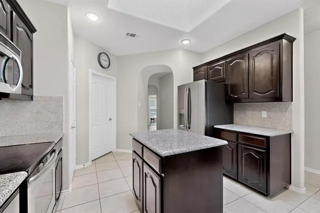a kitchen with stainless steel appliances granite countertop a stove and a sink