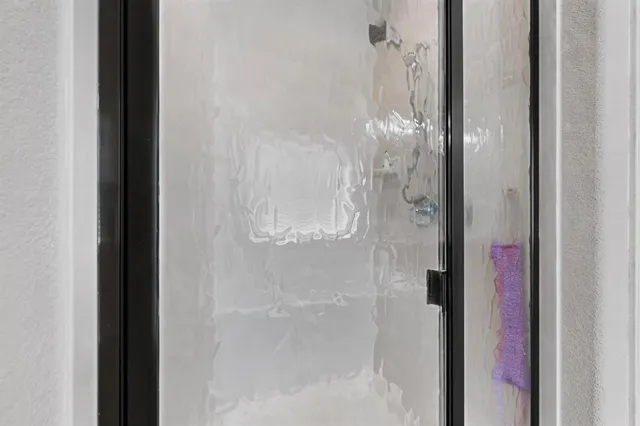 a bathroom with a glass shower door