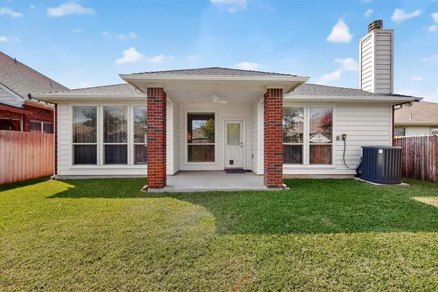 a view of a house with a yard and porch