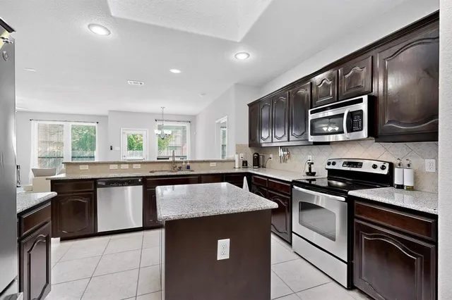 a kitchen with a sink stove and microwave