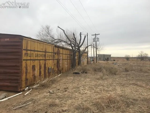 a view of backyard with wooden fence