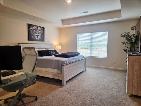 a bedroom with a bed and wall painting