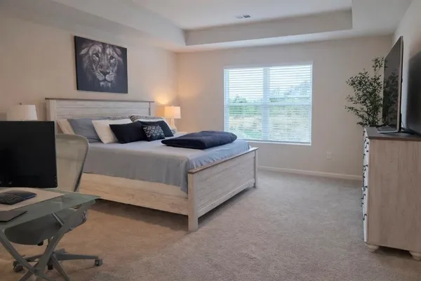 an aerial view of residential houses with outdoor space and trees