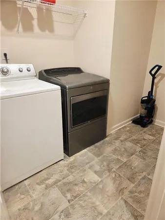 a bedroom with a bed window and dresser
