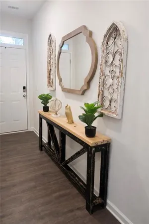 a kitchen with stainless steel appliances granite countertop a stove a sink dishwasher a refrigerator and a microwave oven with wooden floor