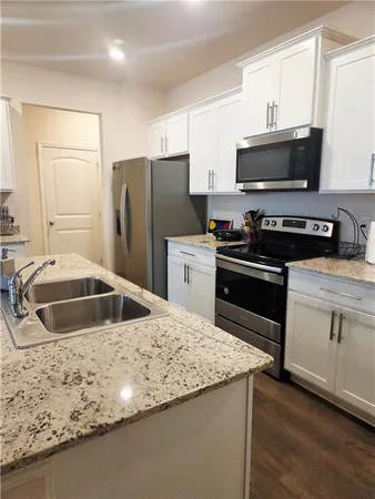 a bathroom with a sink a mirror and a vanity