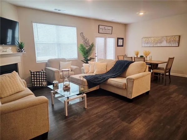 a dining room with furniture and wooden floor