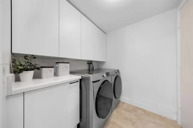 a utility room with sink dryer and washer