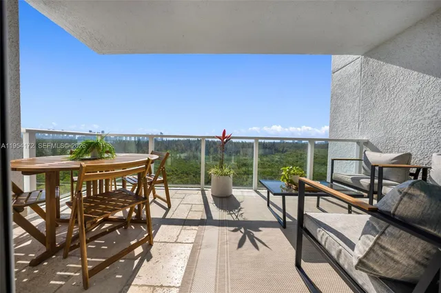 a view of a chairs and table in the balcony