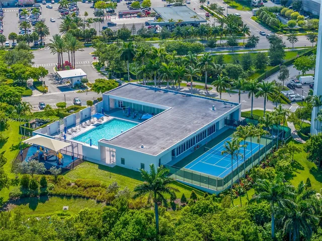 an aerial view of a house with swimming pool outdoor seating and yard