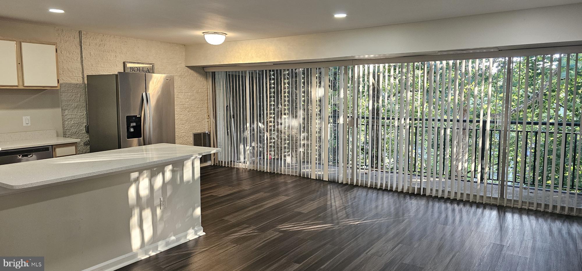 1802 Metzerott Road, Unit 503 Silver Spring, MD 20903 - Photo 1 of 11 a kitchen with stainless steel appliances granite countertop a refrigerator a sink and wooden floors