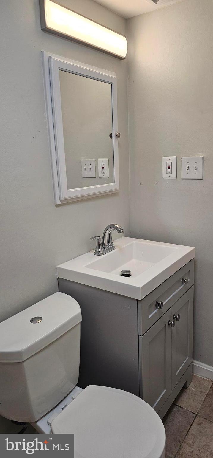 1802 Metzerott Road, Unit 503 Silver Spring, MD 20903 - Photo 7 of 11 a bathroom with a sink toilet and mirror