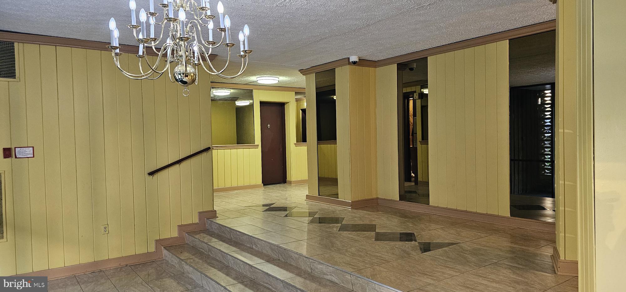 1802 Metzerott Road, Unit 503 Silver Spring, MD 20903 - Photo 9 of 11 a view of a chandelier in a livingroom