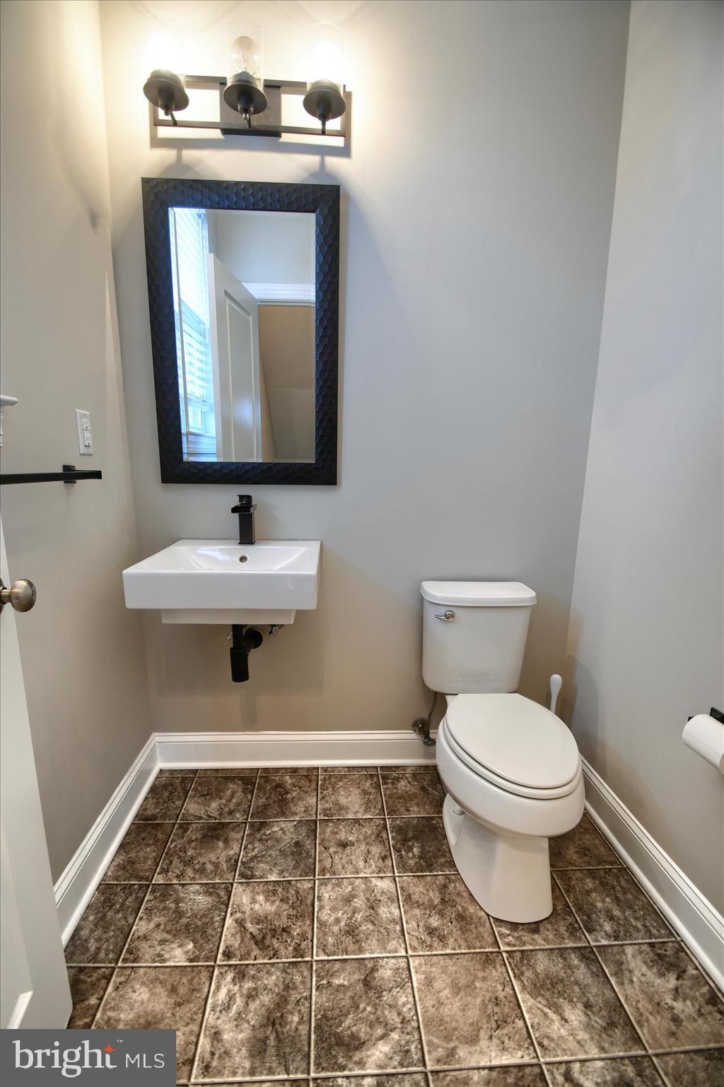 39 North Mitchell Avenue Lansdale, PA 19446 - Photo 7 of 39 a bathroom with a toilet sink and mirror