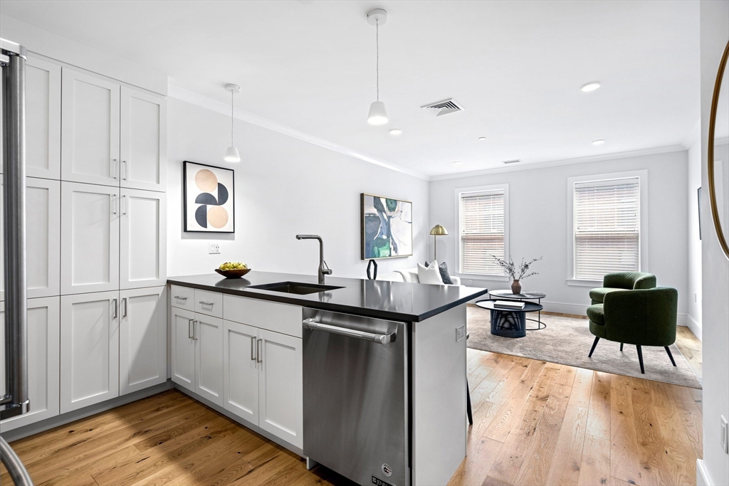 30 Polk Street, Unit 208 Boston, MA 02129 - Photo 4 of 24 a kitchen with stainless steel appliances granite countertop a stove a sink and a refrigerator