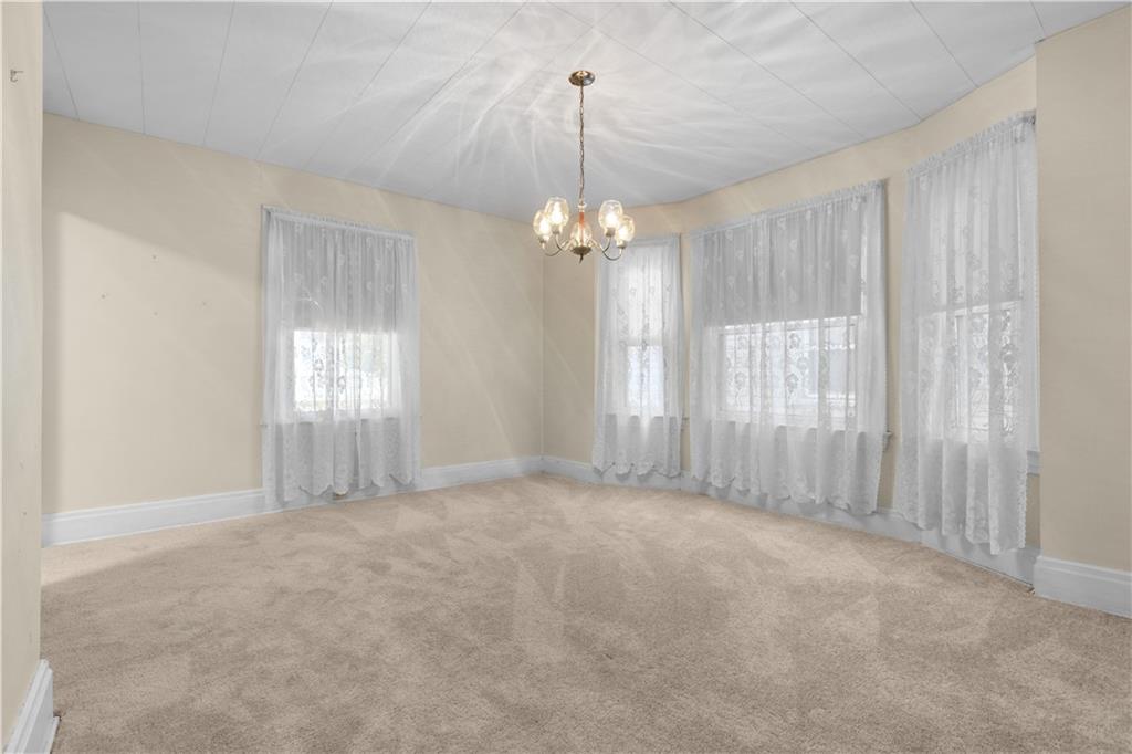 706 Nevin Avenue Sewickley, PA 15143 - Photo 12 of 40 a view of a big room with windows and chandelier fan