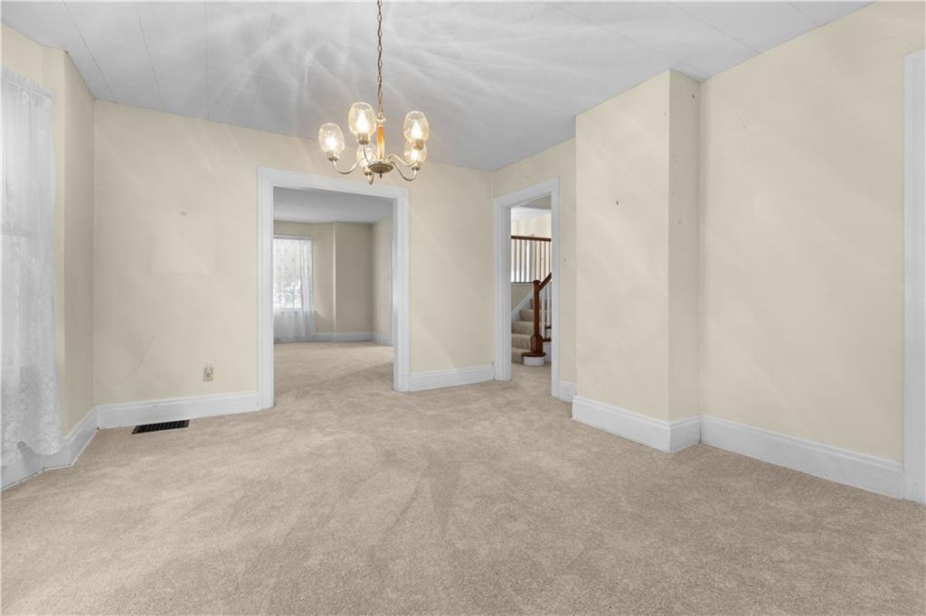 706 Nevin Avenue Sewickley, PA 15143 - Photo 13 of 40 an empty room with chandelier fan and windows