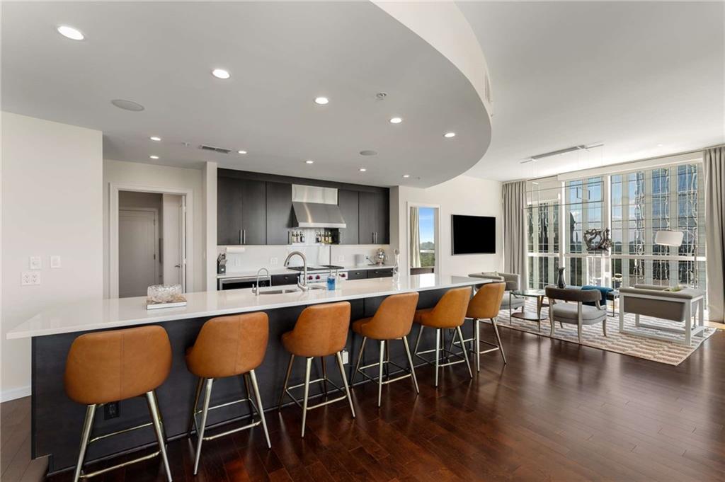 3325 Piedmont Road Northeast, Unit 2006 Atlanta, GA 30305 - Photo 13 of 78 a dining room with furniture wooden floor and a floor to ceiling window