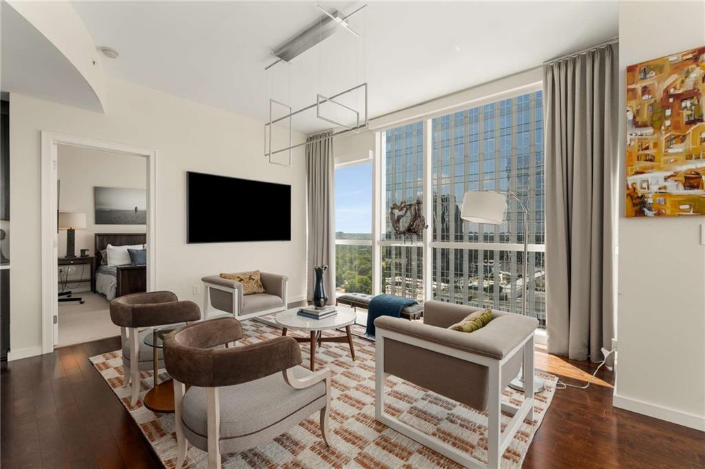 3325 Piedmont Road Northeast, Unit 2006 Atlanta, GA 30305 - Photo 15 of 78 a living room with furniture a flat screen tv and a floor to ceiling window